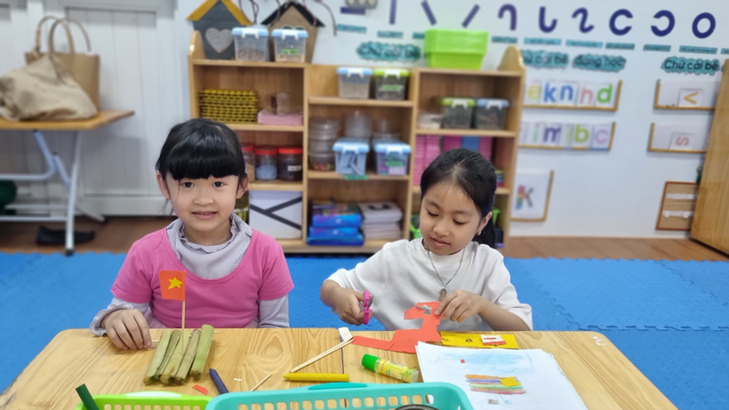 A picture containing text, sitting, indoor, person
Description automatically generated