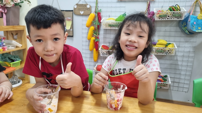 A picture containing table, little, child, person
Description automatically generated