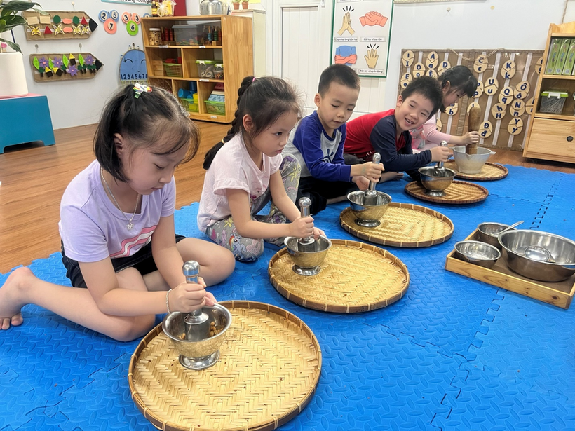 A group of children sitting around a table with food on it
Description automatically generated with medium confidence