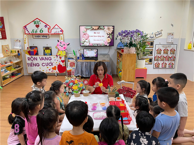 A group of children sitting around a table

Description automatically generated
