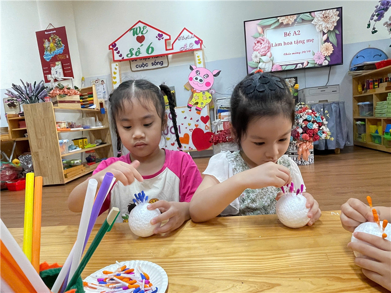 Two girls making crafts at a table

Description automatically generated