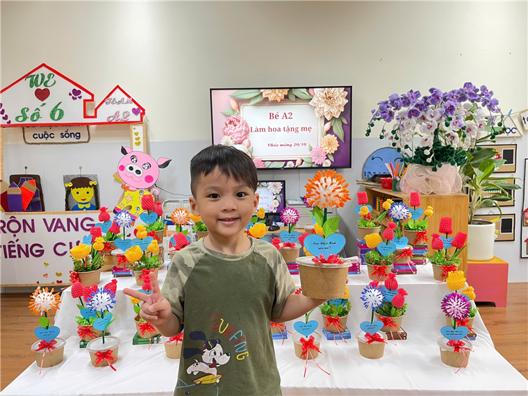 A child holding a potted plant

Description automatically generated