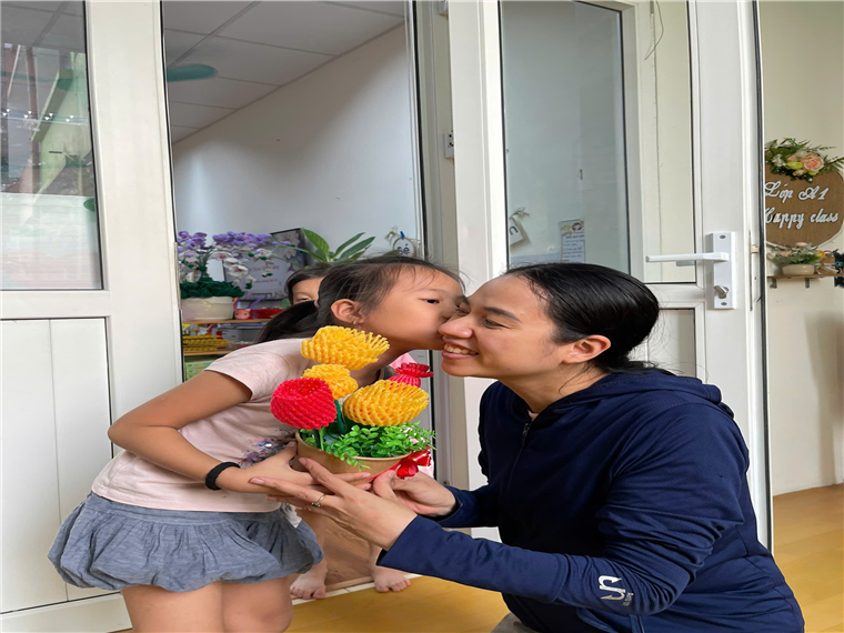 A person kissing a child's cheek

Description automatically generated