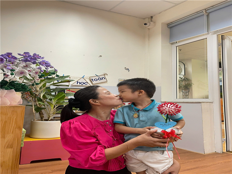 A person kissing a child

Description automatically generated