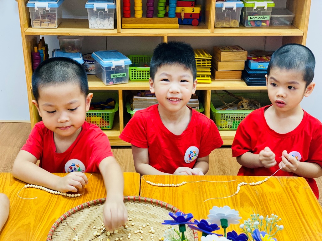 A group of young boys in red shirts sitting at a table
Description automatically generated