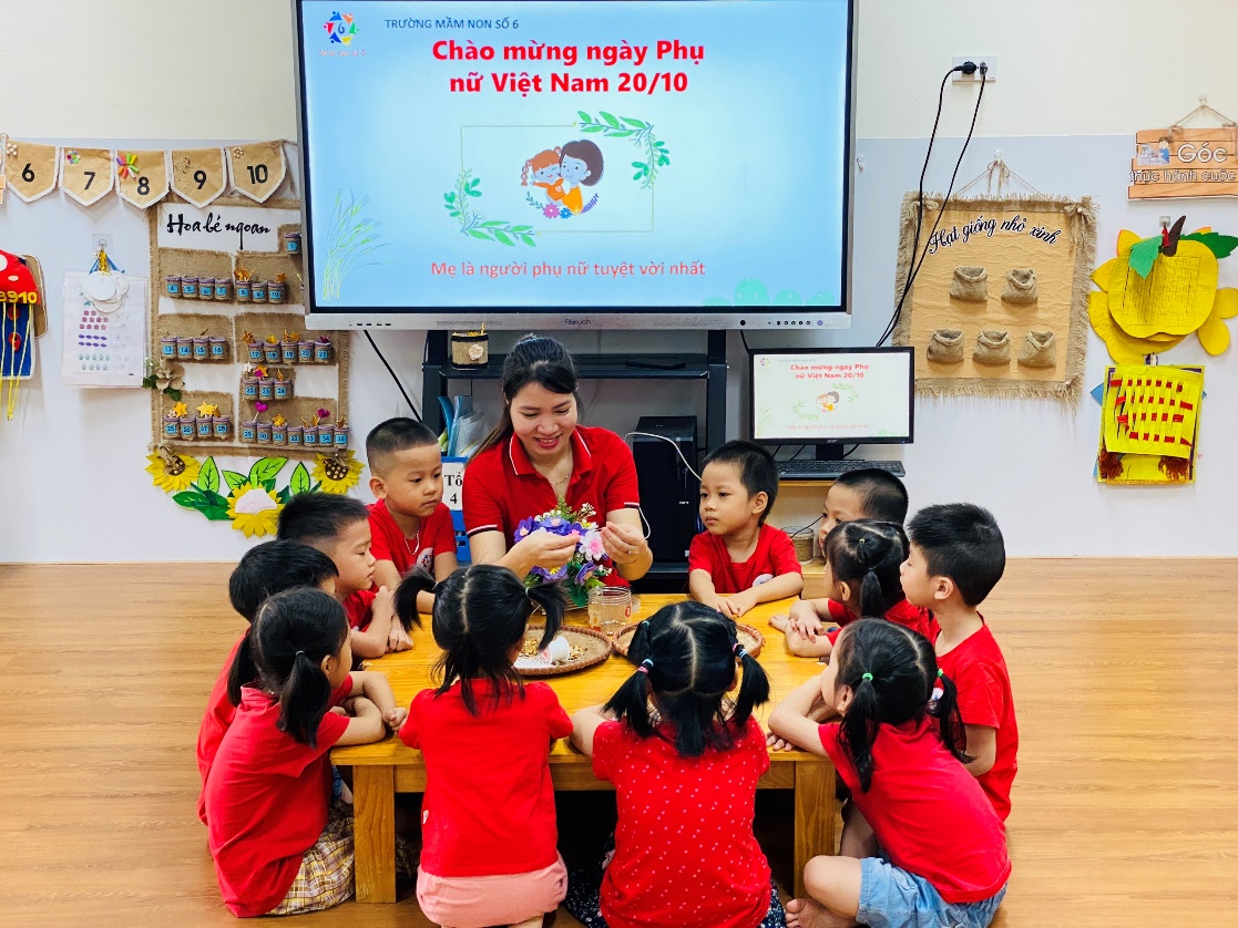 A group of children sitting around a table
Description automatically generated