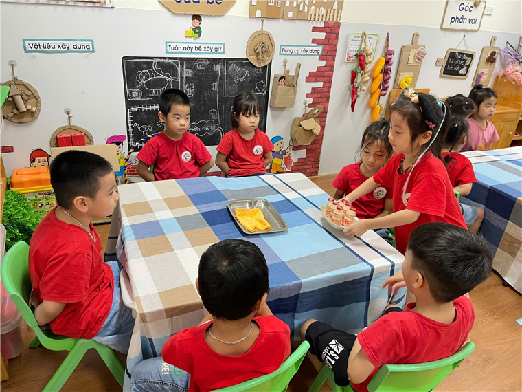 A group of children sitting around a table
Description automatically generated