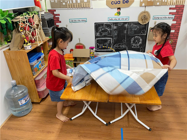 Two girls in a classroom
Description automatically generated