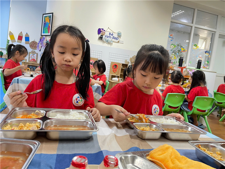 A group of girls eating food
Description automatically generated