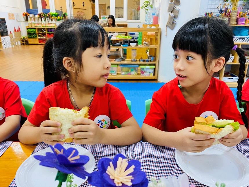 Two girls eating at a table
Description automatically generated