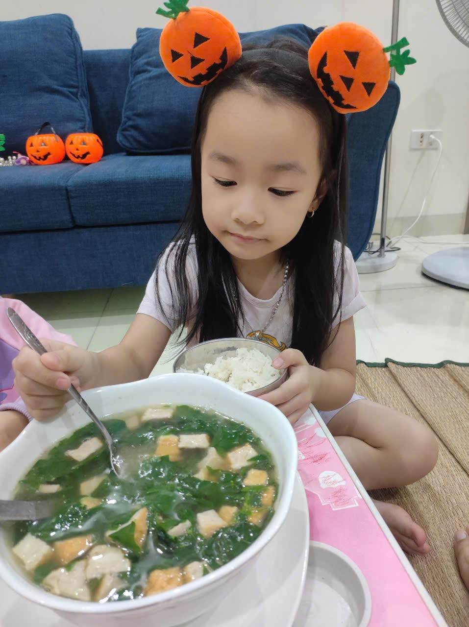 A child eating a soup
Description automatically generated