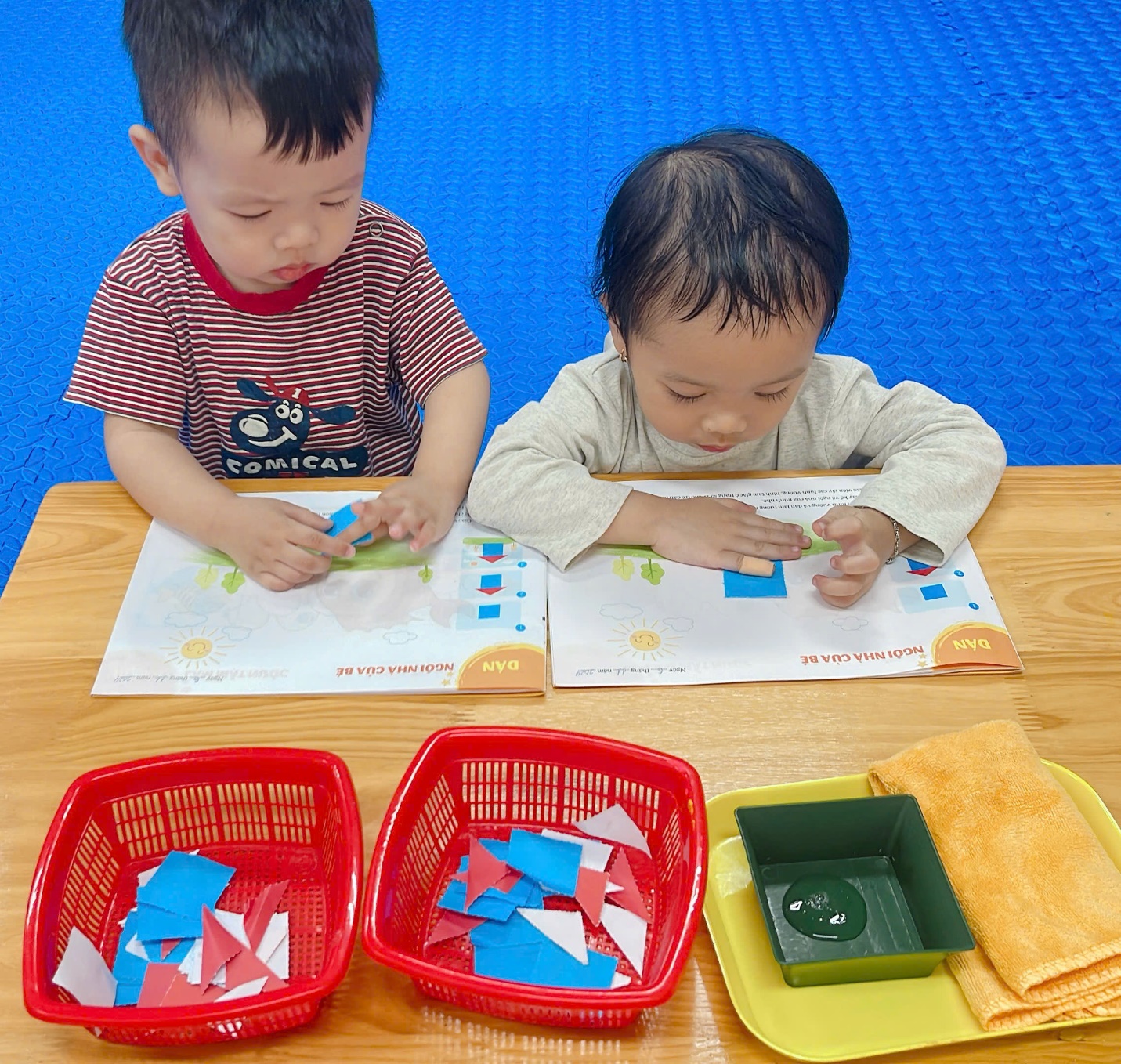 Two children sitting at a table
Description automatically generated