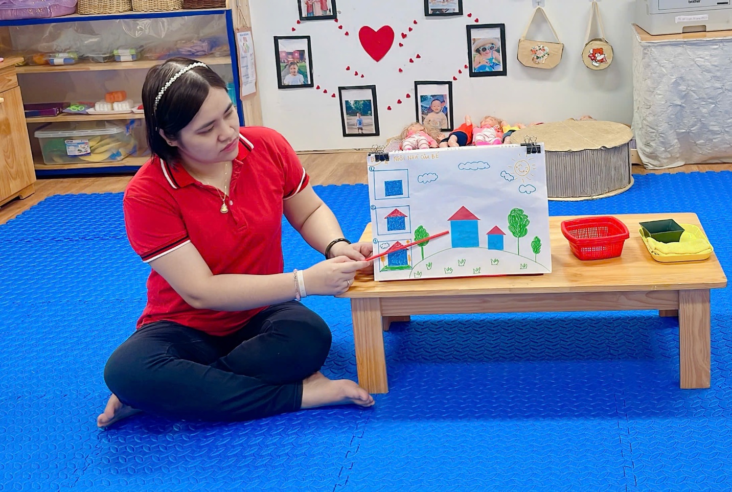 A person sitting on the floor painting
Description automatically generated