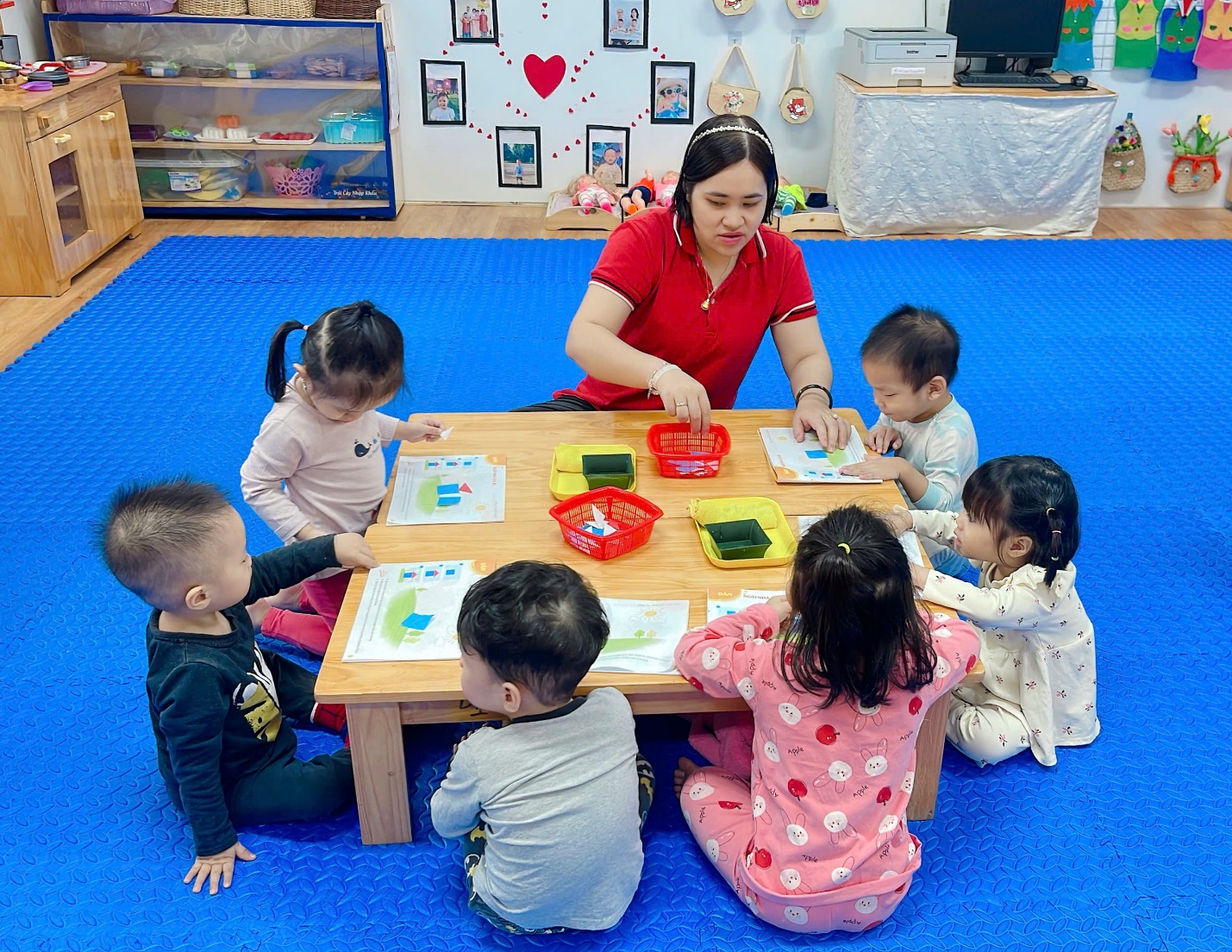 A group of children sitting around a table
Description automatically generated
