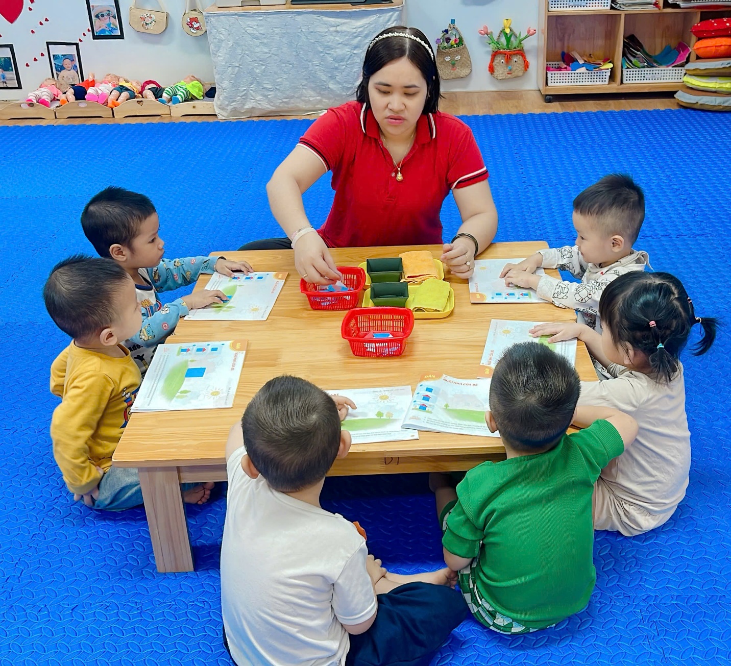 A group of children sitting around a table
Description automatically generated