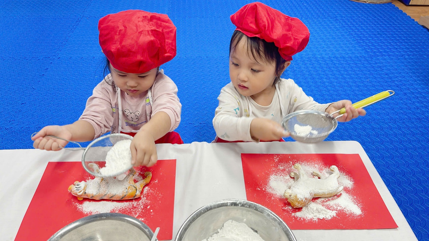 A couple of young children wearing red hats and white shirts

Description automatically generated