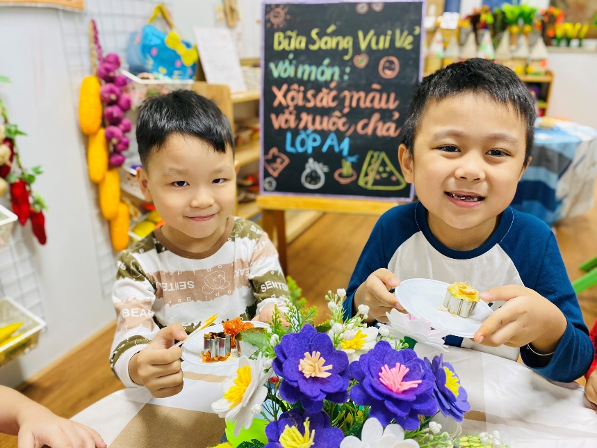 Two boys sitting at a table with flowers

Description automatically generated