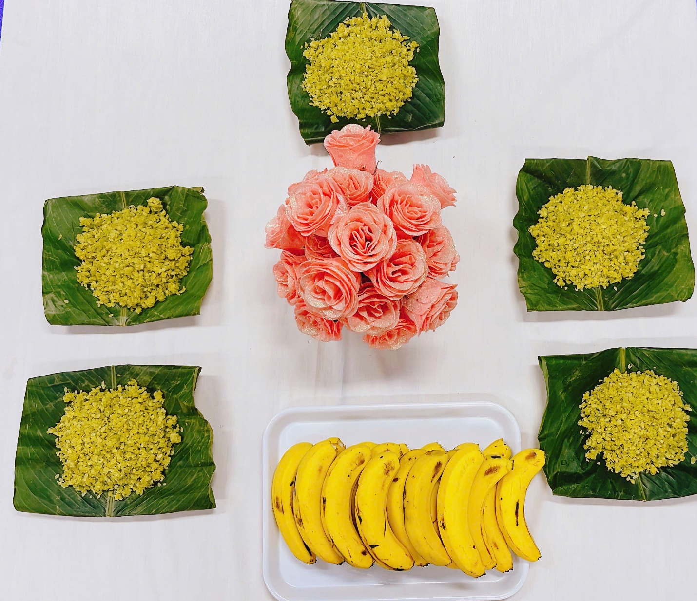 A bunch of bananas and rice on leaves

Description automatically generated