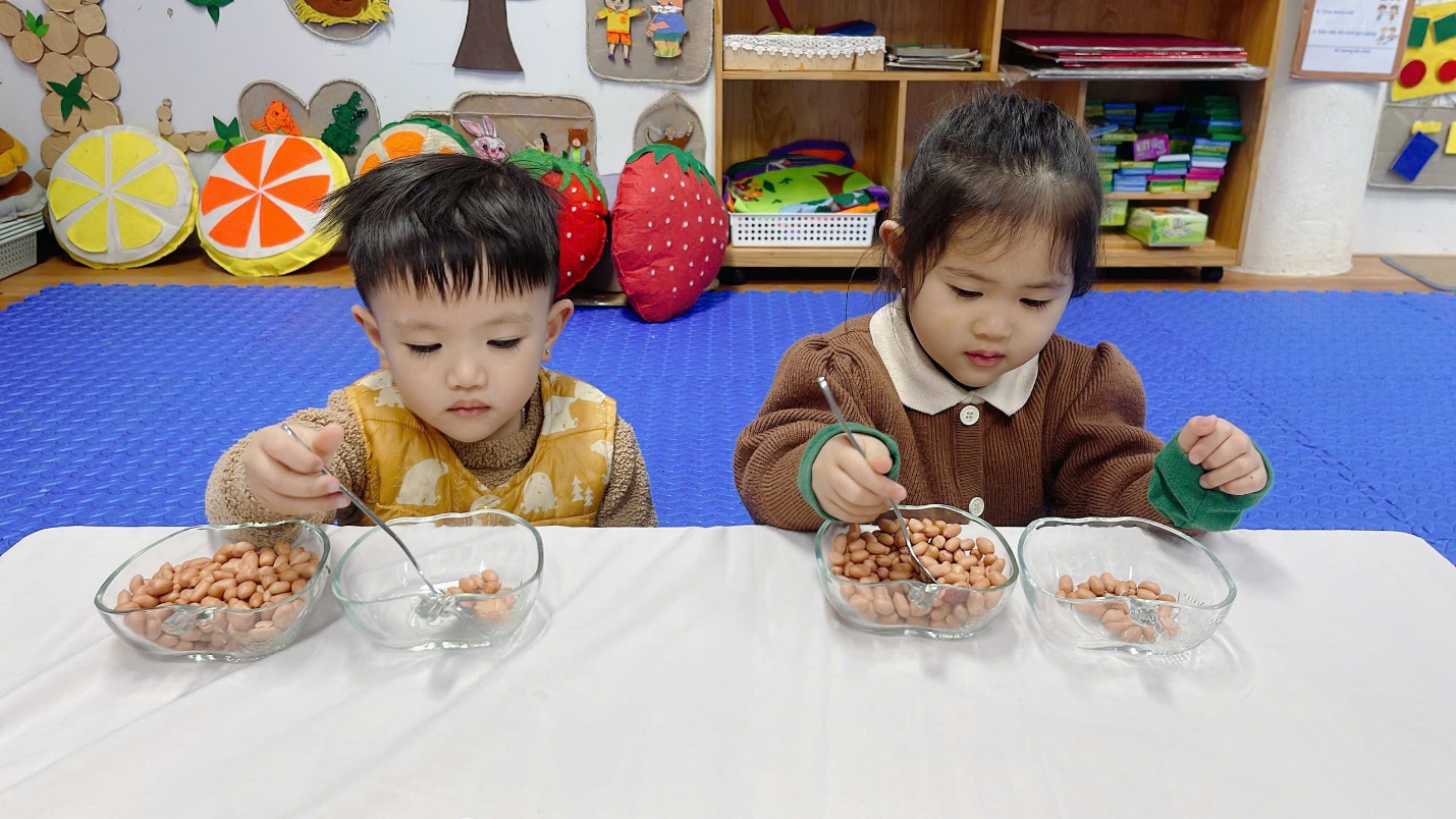 A couple of children eating cereal

Description automatically generated