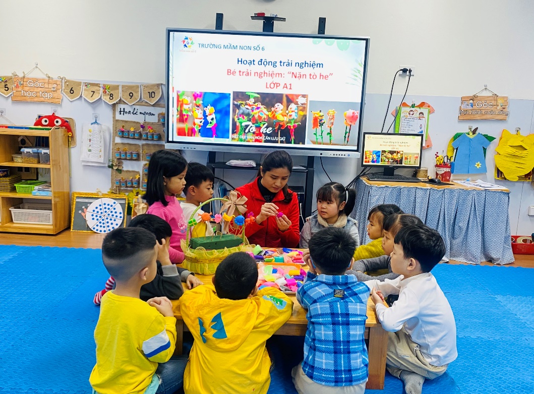 A group of children sitting around a table
Description automatically generated