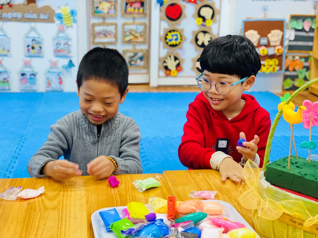 Two boys sitting at a table
Description automatically generated