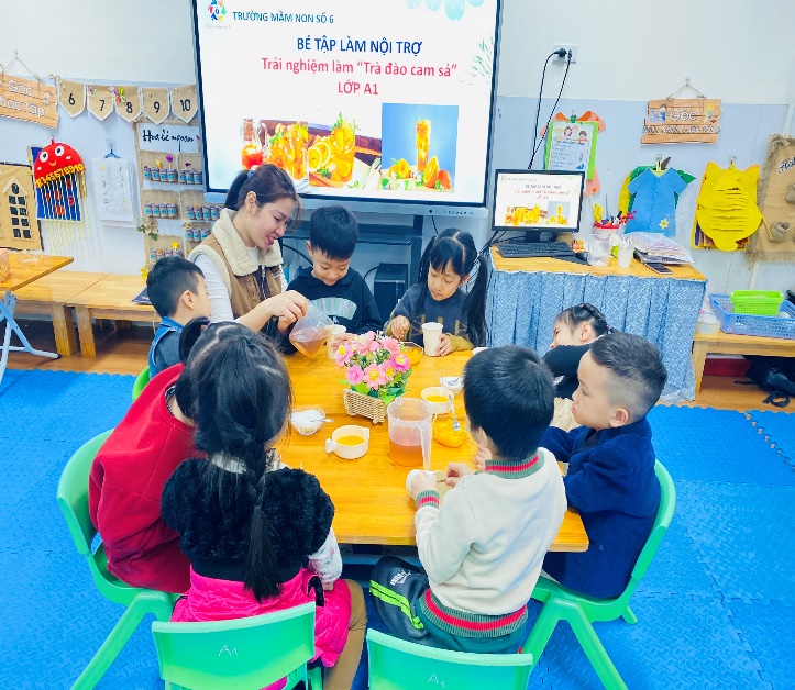 A group of children sitting around a tableDescription automatically generated