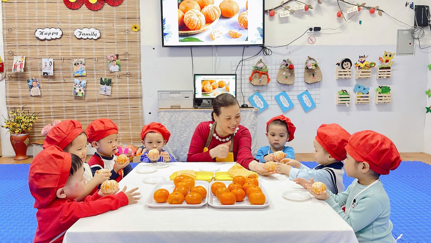 A group of children sitting at a table with food
Description automatically generated