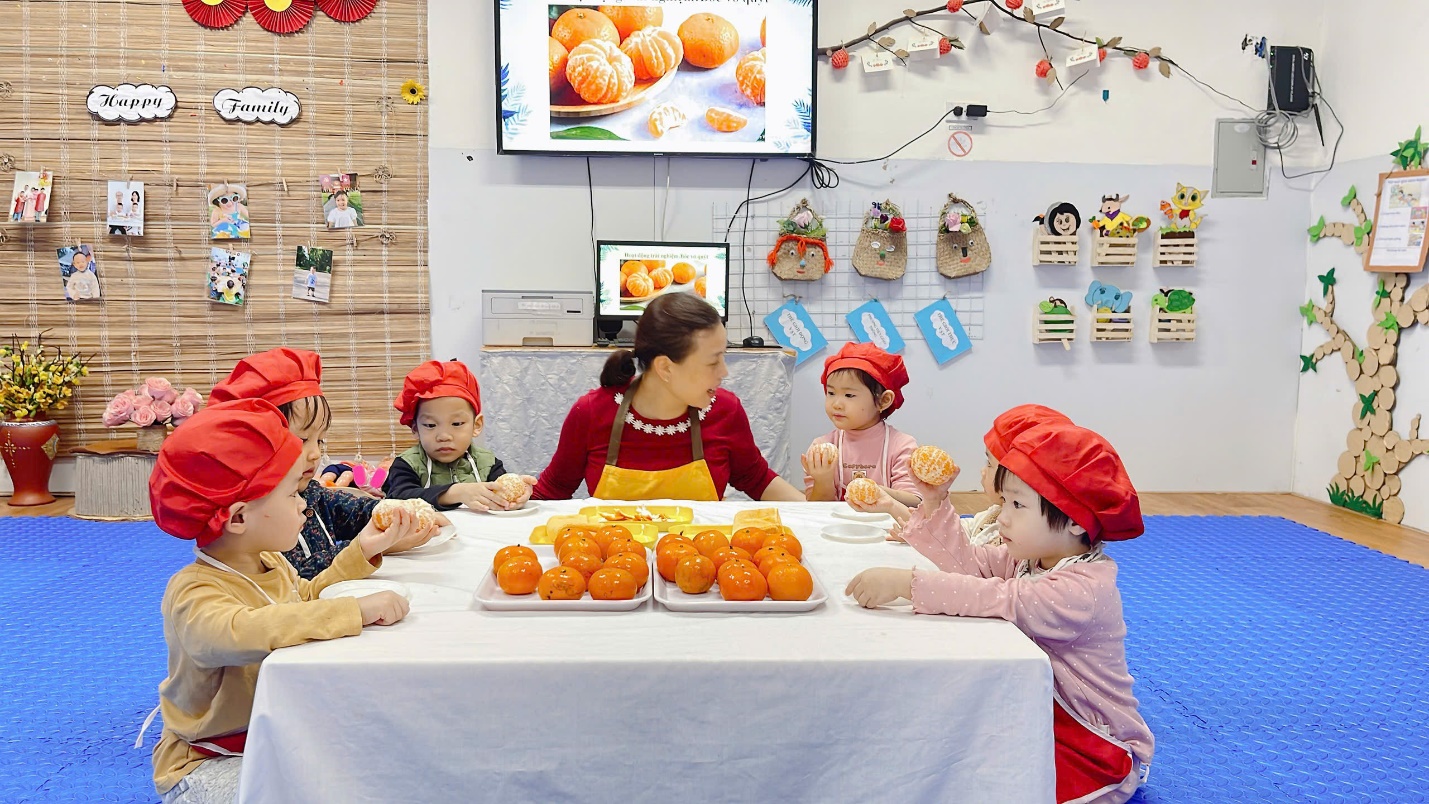 A group of people sitting at a table with food
Description automatically generated