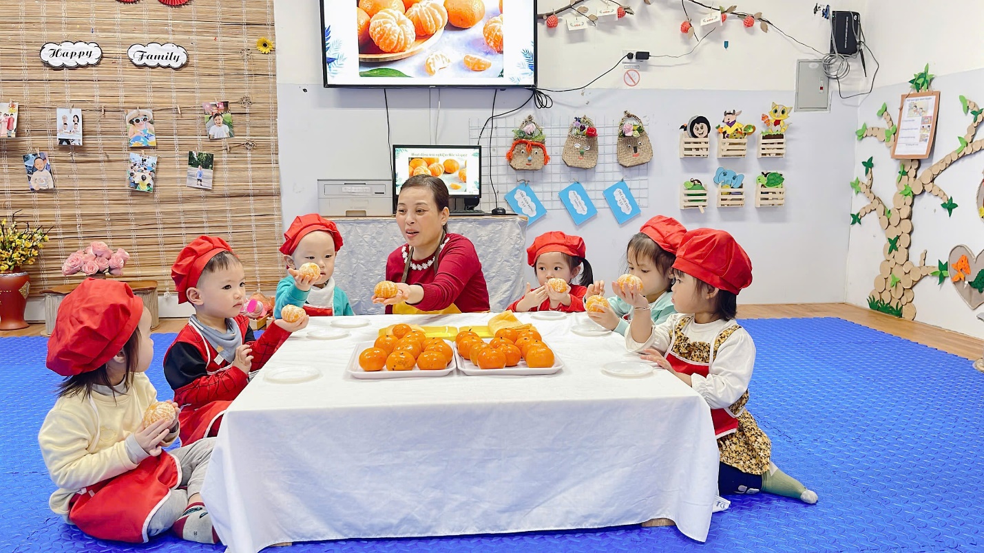 A group of children sitting at a table
Description automatically generated