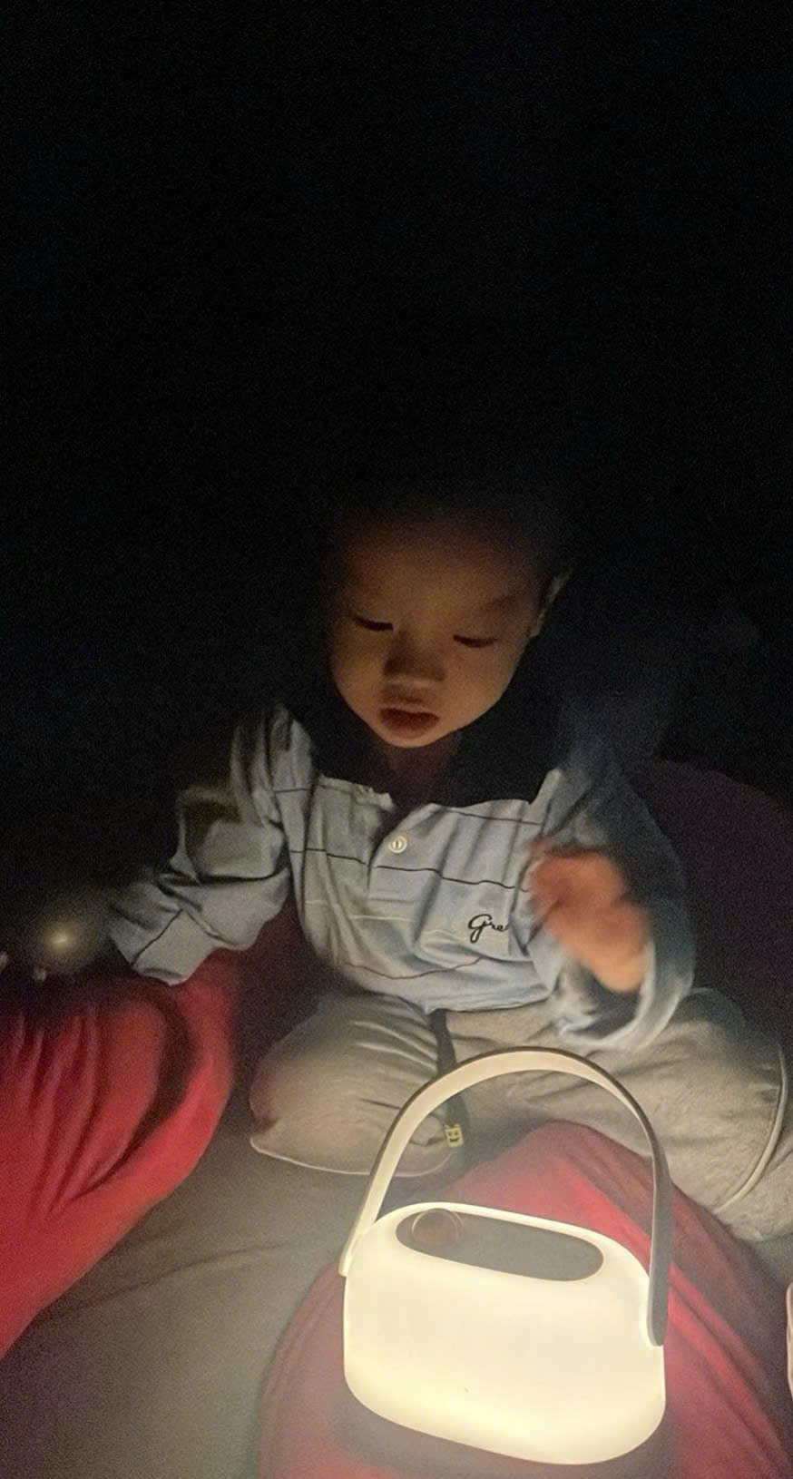 A baby playing with a toy
Description automatically generated