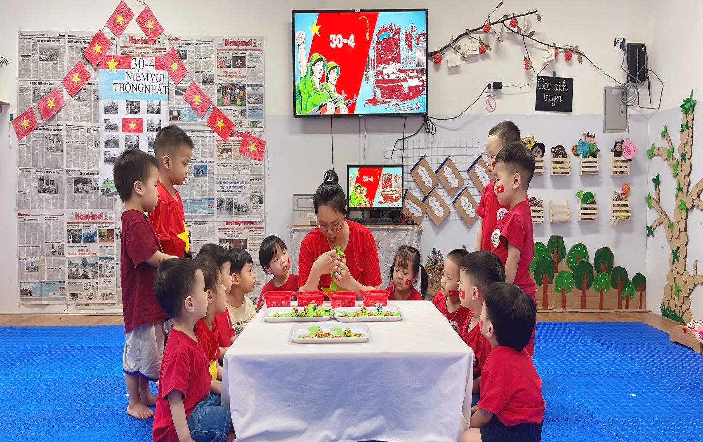 A group of children sitting around a table
Description automatically generated