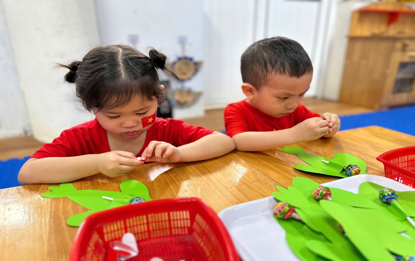 A child and child making crafts
Description automatically generated