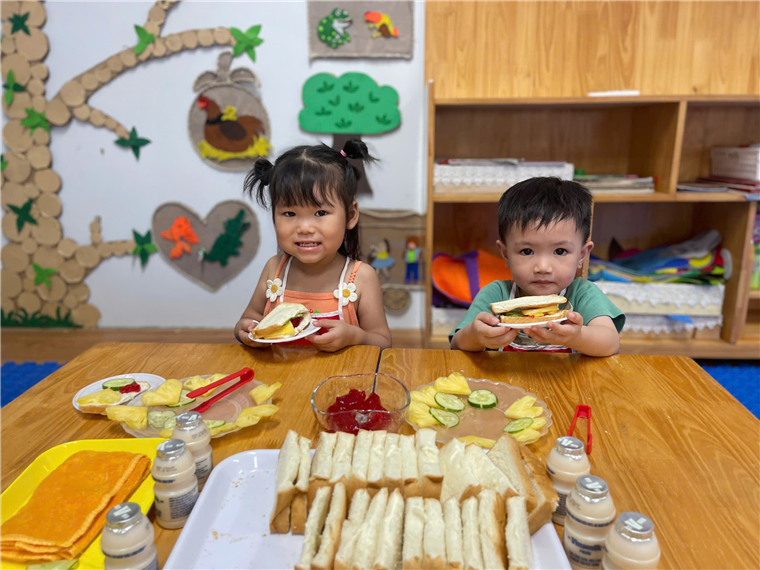 Two children eating at a table
Description automatically generated