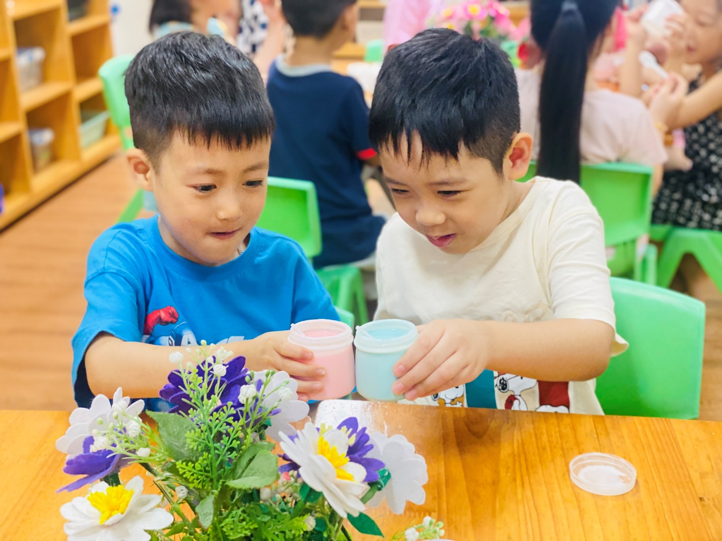 Two boys sitting at a table with flowers
AI-generated content may be incorrect.