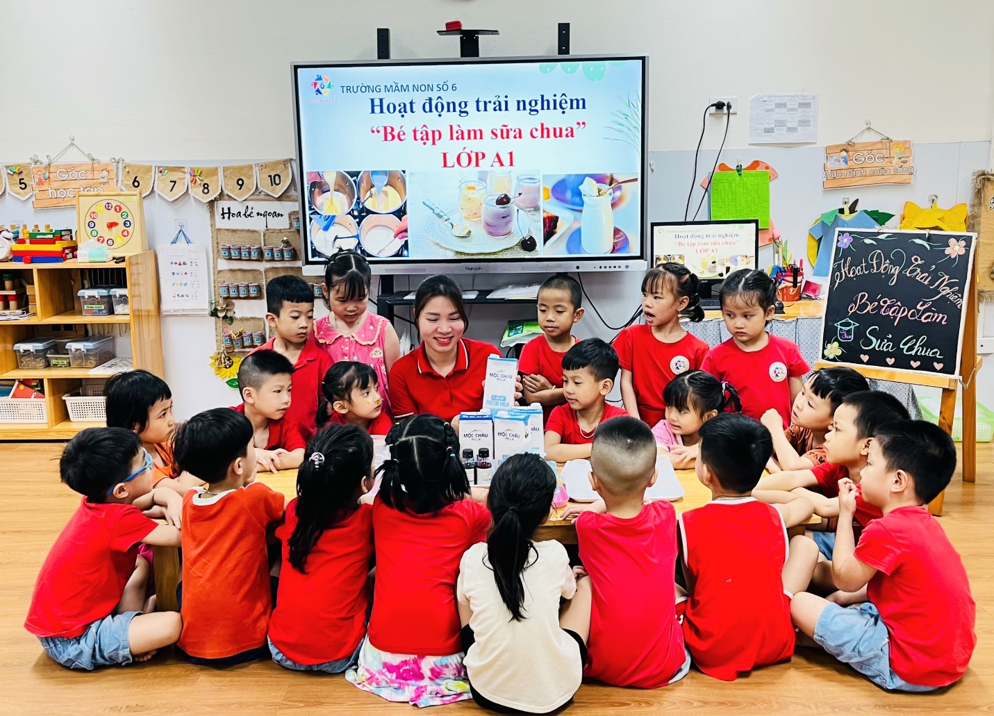 A group of children sitting around a table
AI-generated content may be incorrect.