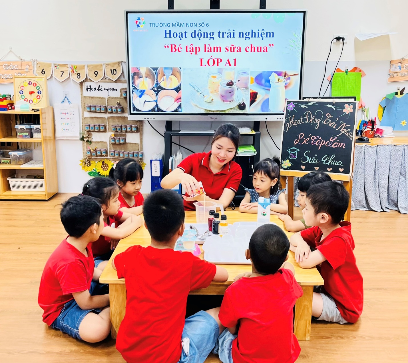 A group of children sitting around a table
AI-generated content may be incorrect.
