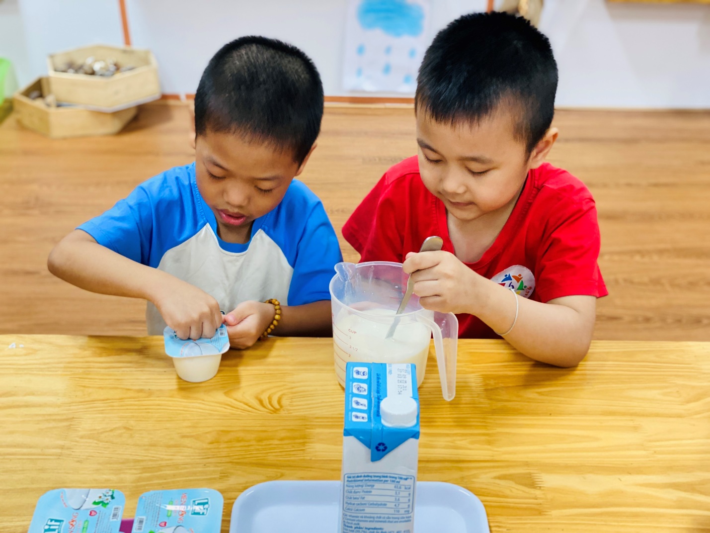 Two young boys sitting at a table
AI-generated content may be incorrect.