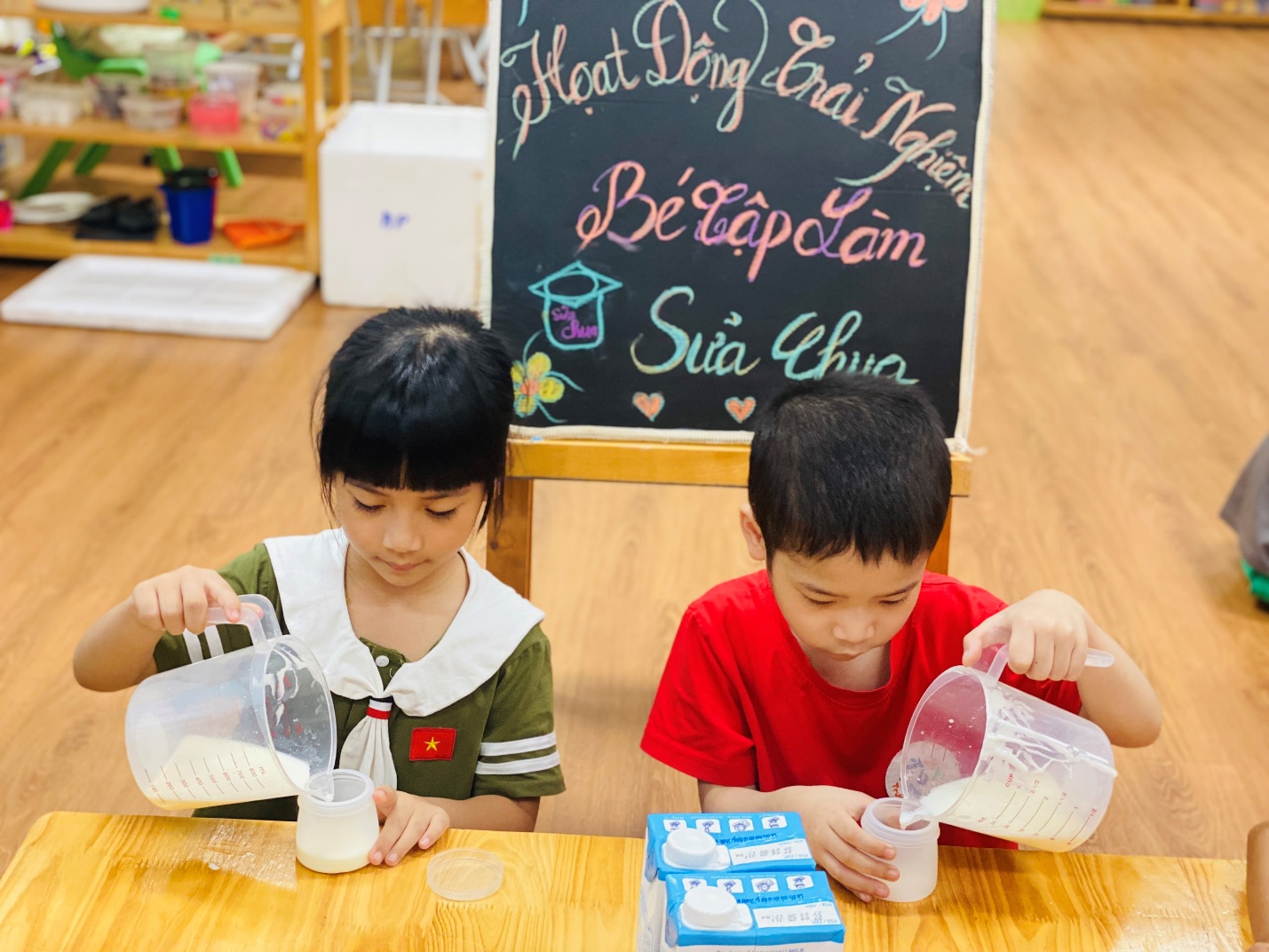 A couple of children pouring milk into cups
AI-generated content may be incorrect.